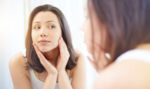 a lady checking her aesthetic score in the mirror